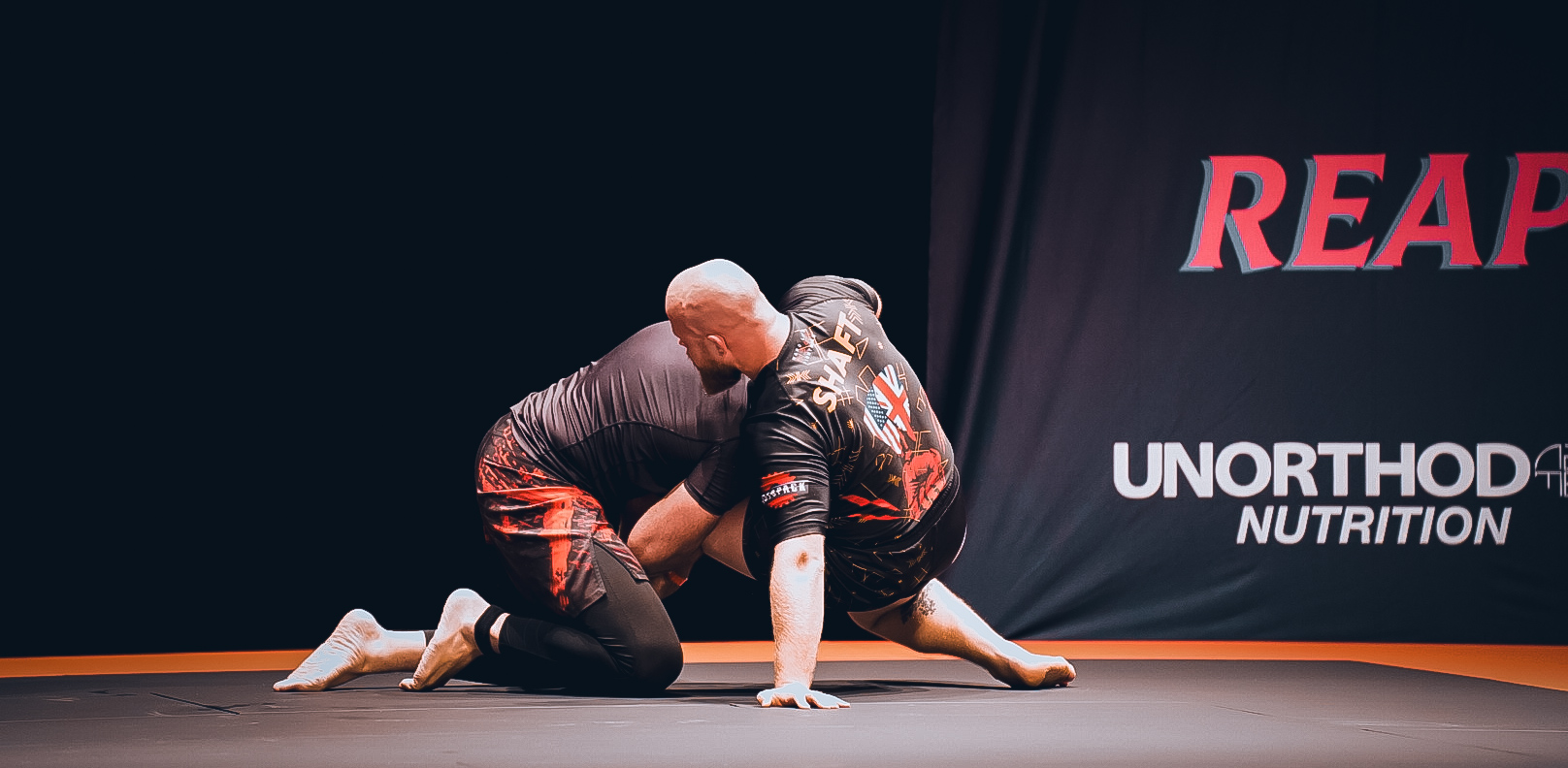 Heavyweight grappler controlling top position on the GrappleMax stage